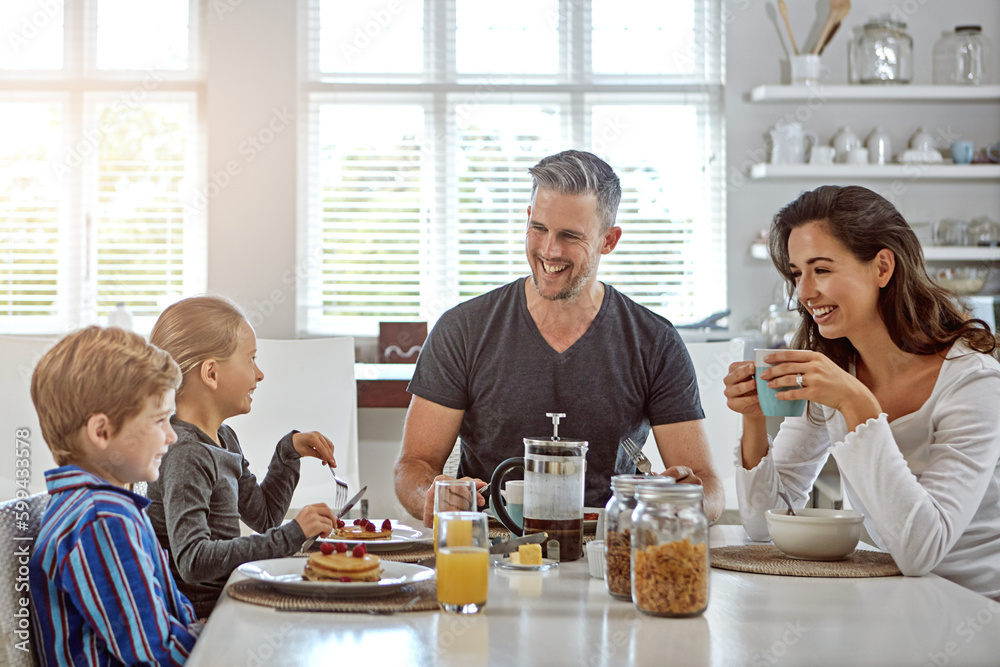 Never a dull moment when theyre together. a family having breakfast together.