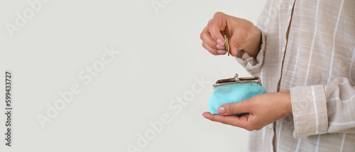 Woman putting coins in wall...