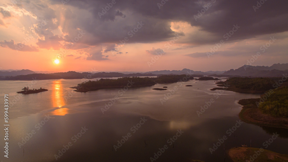 aerial view amazing sky above the lake in sunset at Pompee view point Kanchanaburi Thailand..Imagine a fantasy bright sky at sunset..Gradient color. Sky texture, abstract nature background. aerial view amazing sky above the lake in sunset at Pompee view point Kanchanaburi Thailand..Imagine a fantasy bright sky at sunset..Gradient color. Sky texture, abstract nature background.