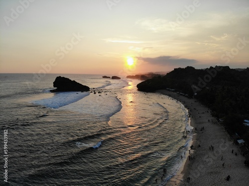 The beautiful landscape and scenery of ocean during sunset and sunny day. The long coastal beach with sand and rocky beach. Location in Pacitan, East Java Province, Indonesia.