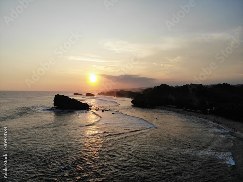 The beautiful landscape and scenery of ocean during sunset and sunny day. The long coastal beach with sand and rocky beach. Location in Pacitan, East Java Province, Indonesia.