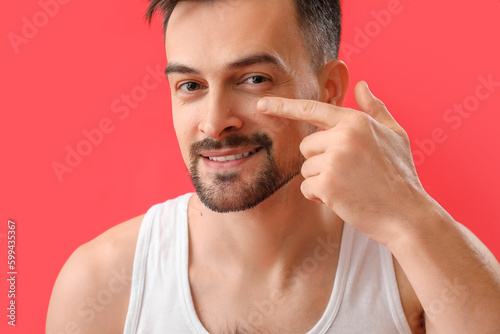 Young man pointing at his m...