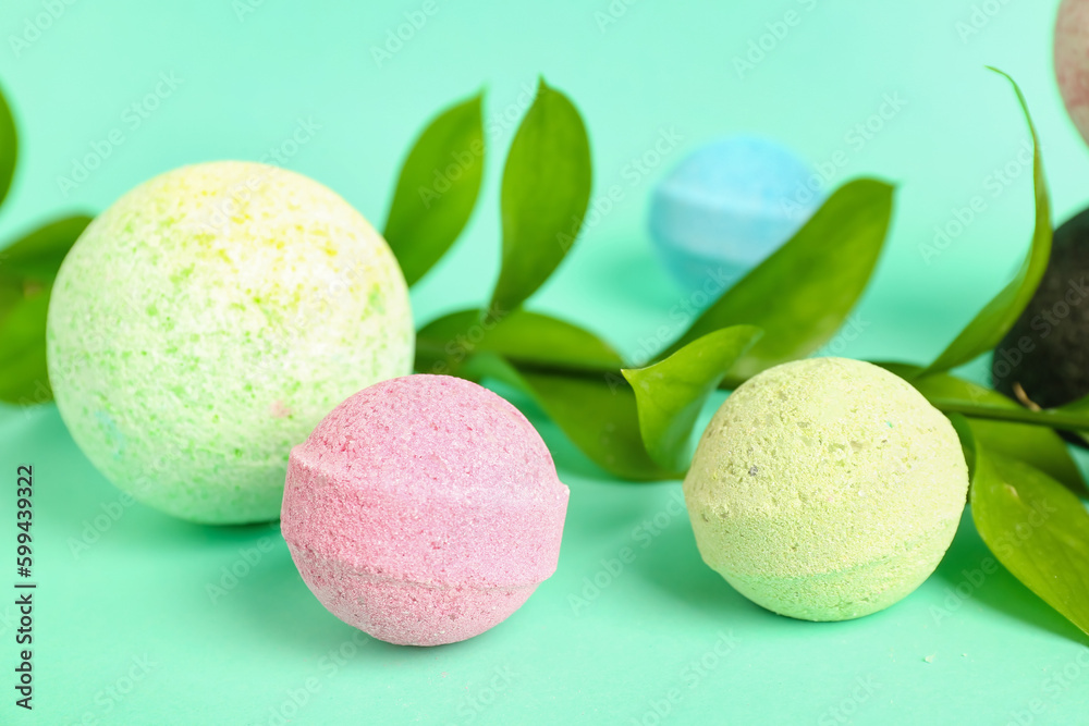Bath bombs with plant branch on color background, closeup Bath bombs with plant branch on color background, closeup