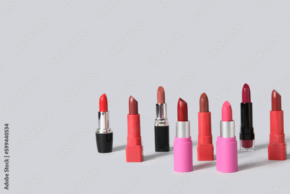 Set of beautiful lipsticks on grey background Set of beautiful lipsticks on grey background