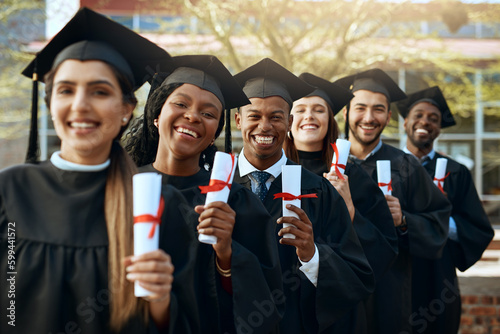 The start of many more successes to come. Portrait of a group of young students holding their diplomas on graduation day.