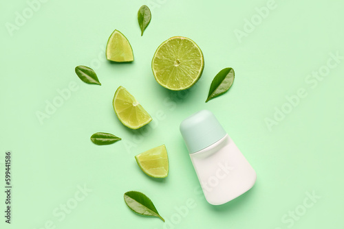 Deodorant with lime slices and leaves on light green background