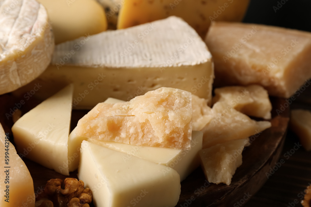 Plate with different types of tasty cheese on table, closeup