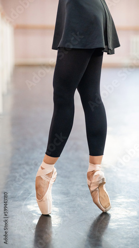Close-up but ballerinas in pointe shoes in a dance class. 