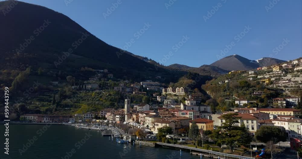 Aerial drone forward view of Tavernola Bergamasca in Italy. Tilt-down and clear sky for copy space Aerial drone forward view of Tavernola Bergamasca in Italy. Tilt-down and clear sky for copy space