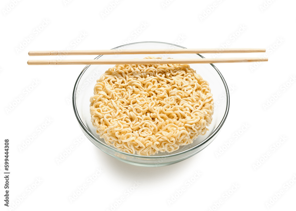 Raw instant noodles in bowl with wooden chopsticks on white background Raw instant noodles in bowl with wooden chopsticks on white background