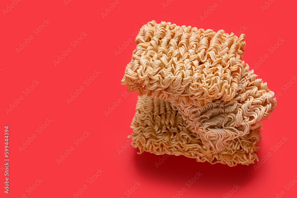 Raw instant noodles on red background Raw instant noodles on red background
