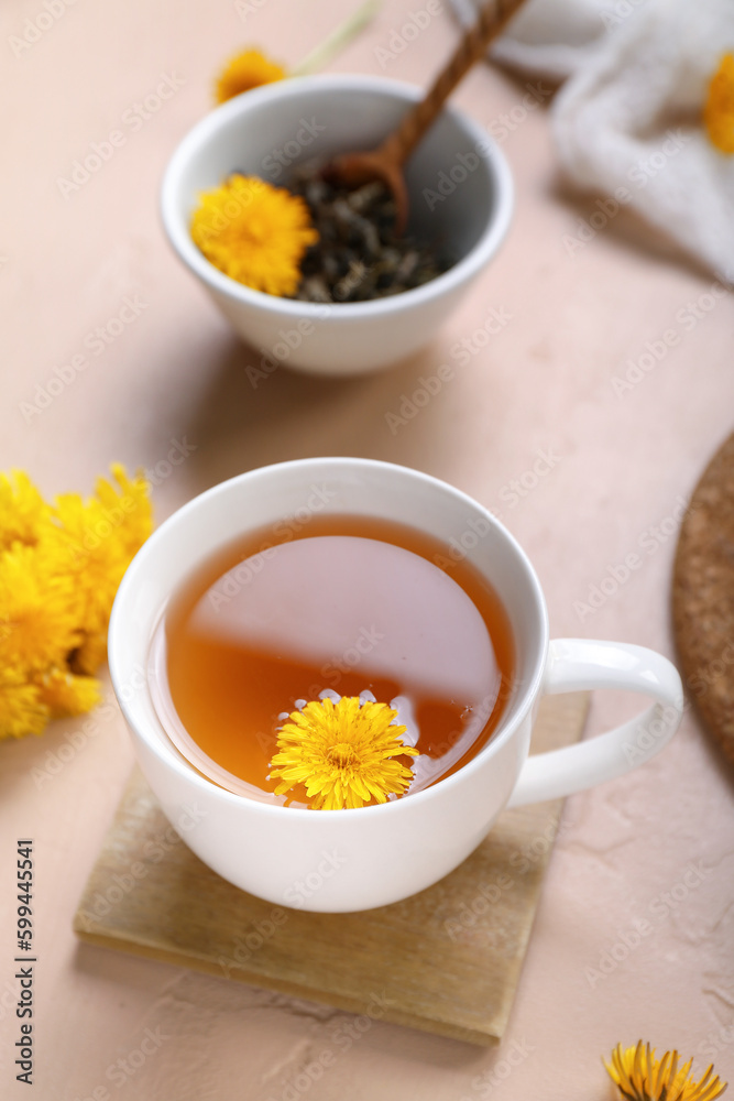 Cup of healthy dandelion tea on beige background Cup of healthy dandelion tea on beige background
