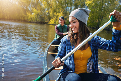 Trying out new things as a couple. a young couple going for a canoe ride on the lake.