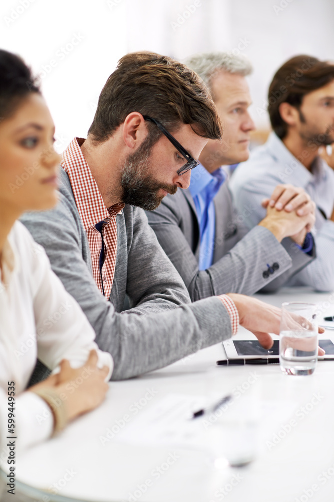 Project debriefing. a group of dedicated business professionals sitting in a row. Project debriefing. a group of dedicated business professionals sitting in a row.