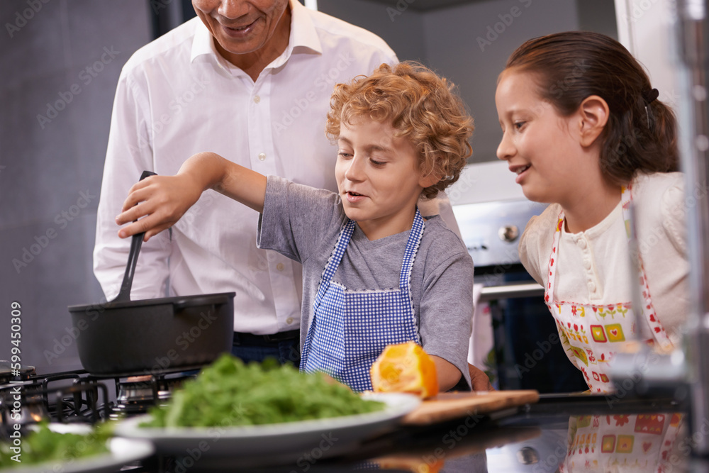 Chef in the making. A brother and sister helping to make dinner at their grandparents house. Chef in the making. A brother and sister helping to make dinner at their grandparents house.