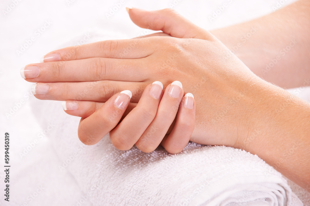 Resting her hands on a soft towel. a womans hands resting on a towel.