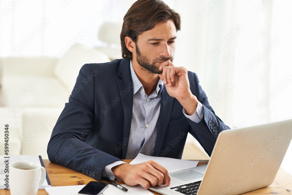 Hmmm, this is interesting...A handsome businessman working on his laptop. Hmmm, this is interesting...A handsome businessman working on his laptop.
