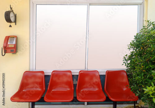 Bus stop with blank board window, clock and red payphone with row fo chair as vintage style