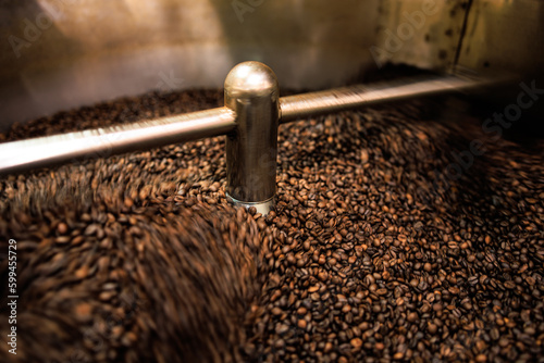 fresh coffee beans roasted spinning cover professional machine close up to soft focus slow shutter speed because want to make motion blur of coffee beans detail concept,