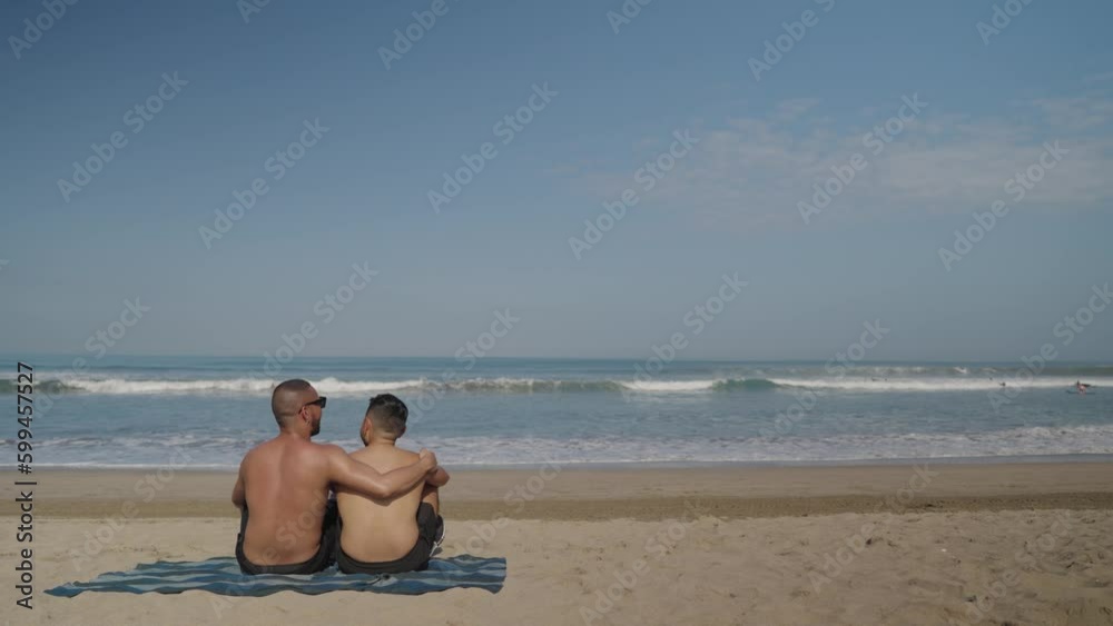 LGBT Gay Men Couple Spending Time at The Beach on a Sunny Day LGBT Gay Men Couple Spending Time at The Beach on a Sunny Day