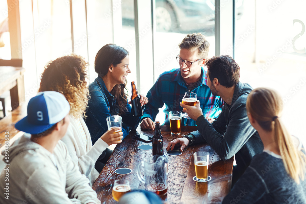 Their go to spot for good times. a group of friends enjoying some beers at a bar. Their go to spot for good times. a group of friends enjoying some beers at a bar.