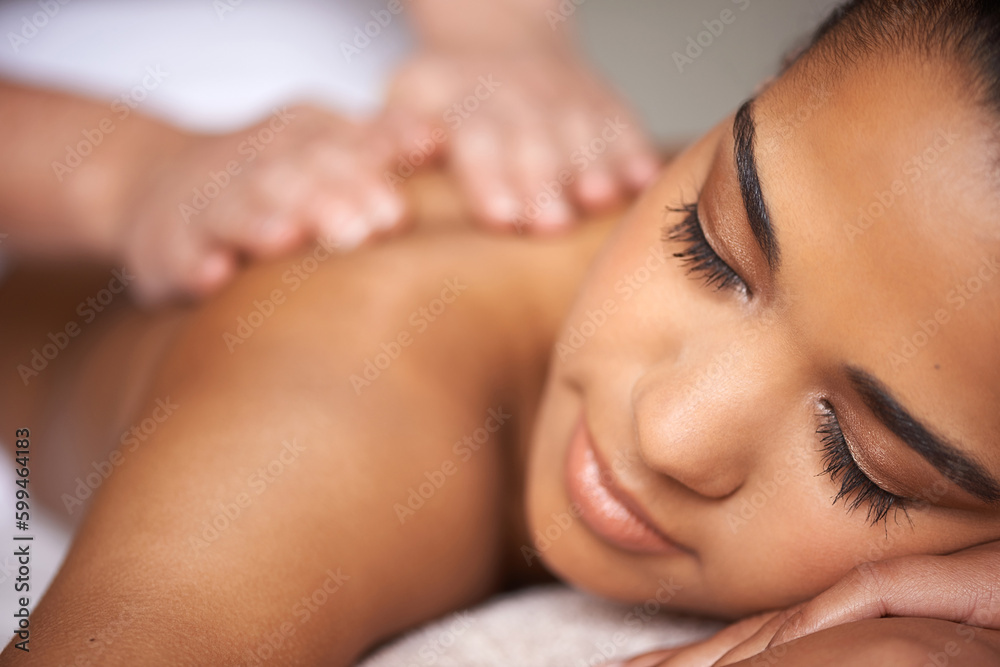 Just getting away from it all...a young woman enjoying a back massage at a spa.