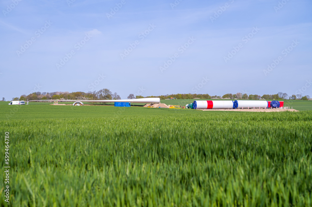 on a field lie the components for a new wind turbine on a field lie the components for a new wind turbine