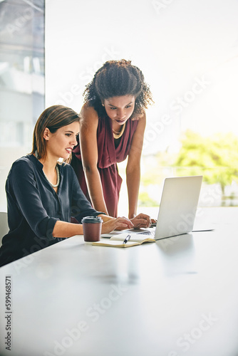 Success is a steady climb that requires hard work. two businesswomen working together on a laptop in an office.