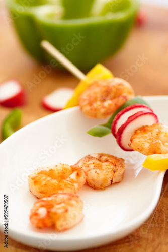 Food, nutrition and prawn on a plate in a restaurant for hospitality in a luxury fine dining establishment. Shrimp, skewer and meal on a kitchen counter ready for serving in a hotel for healthy lunch