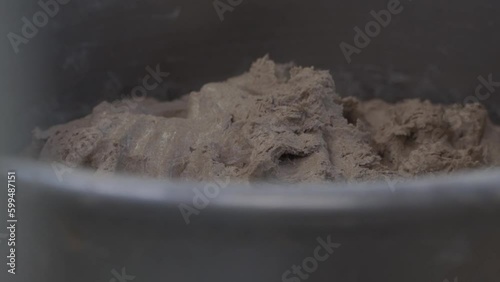 large amount of dough for a large food production in a metal bowl photo