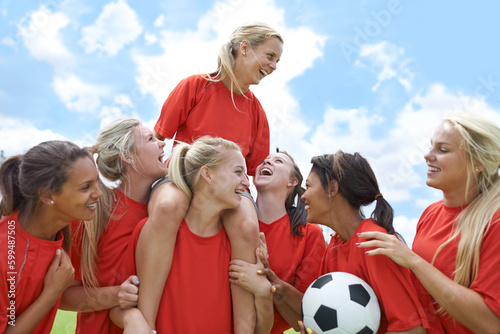 Sports, success and women soccer team winner celebrating victory, achievement or match goal on field. Football, champion and girl group lifting captain in celebration, competition or training triumph photo