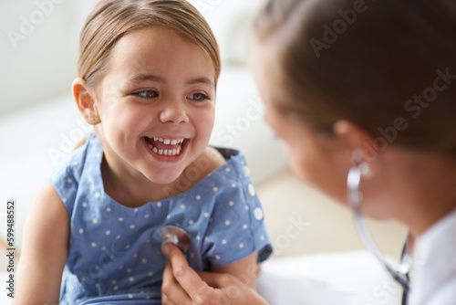 Photos Happy girl, kid and pediatrician with stethoscope for medical consulting, healthy lungs and listening to heartbeat