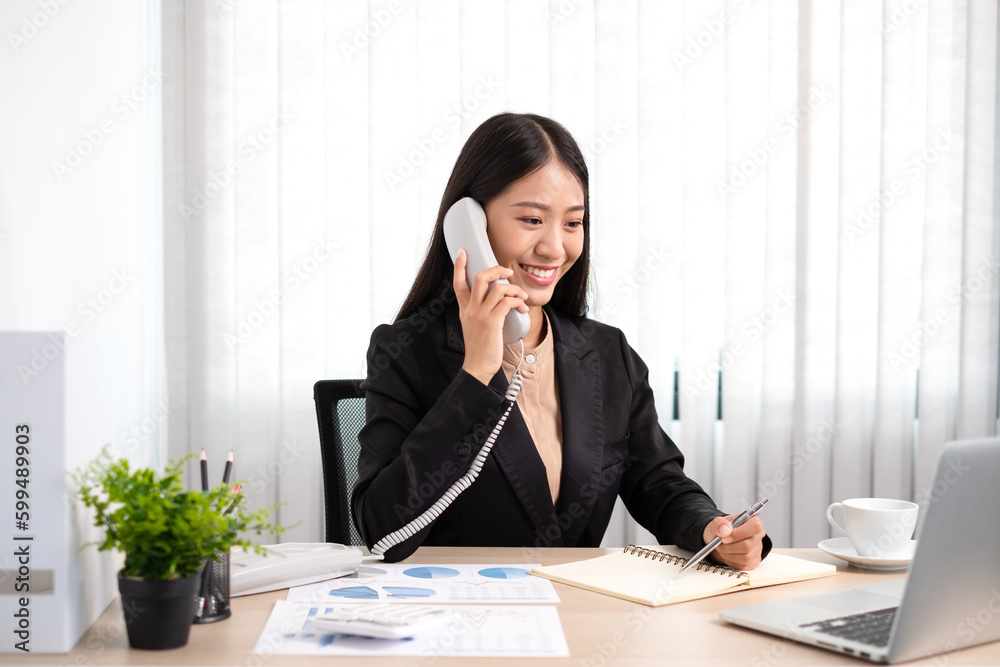 Smart business woman is sitting at workplace and using telephone contact with customers. Smart business woman is sitting at workplace and using telephone contact with customers.