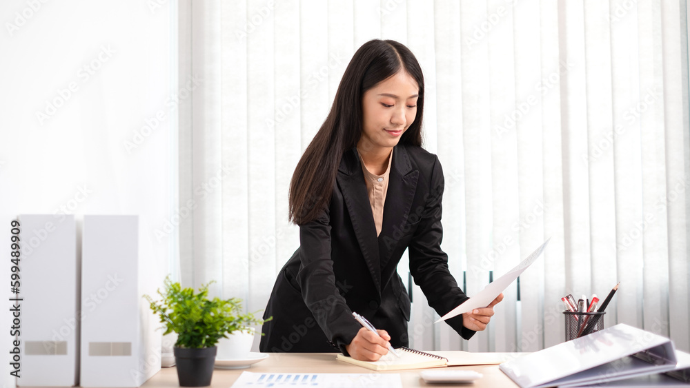 Smart business woman is planing about marketing investment from graph in the office. Smart business woman is planing about marketing investment from graph in the office.