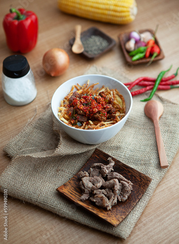 Fototapeta Naklejka Na Ścianę i Meble -  Cumi Pedas is a authentic recipe from Indonesia. Squid is the main ingredients of this menu. Served with rice, peppers, chilli and spoon. 