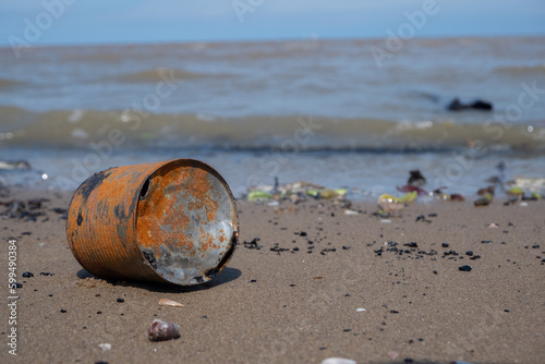 selective focus to a rusty can dumped on the beach. concept photo of environmental pollution and Ecological problemselective focus to a rusty can dumped on the beach. concept photo of environmental po