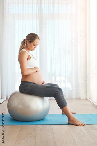 Did you enjoy that little light exercise. a pregnant woman working out with an exercise ball at home.