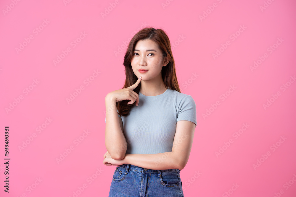 portrait of young asian girl posing on pink background portrait of young asian girl posing on pink background