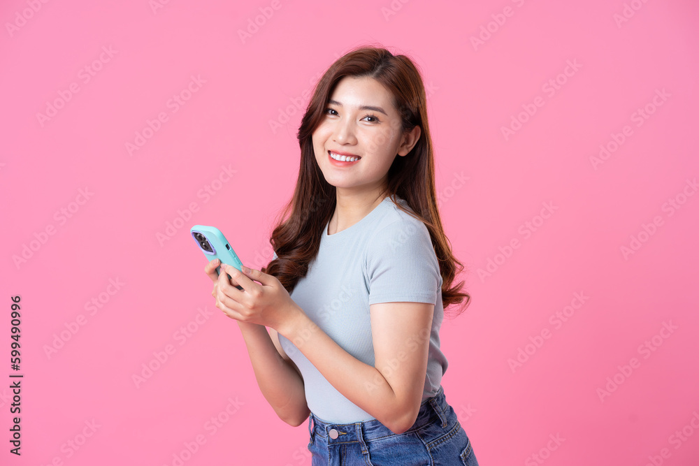 portrait of young asian girl posing on pink background portrait of young asian girl posing on pink background
