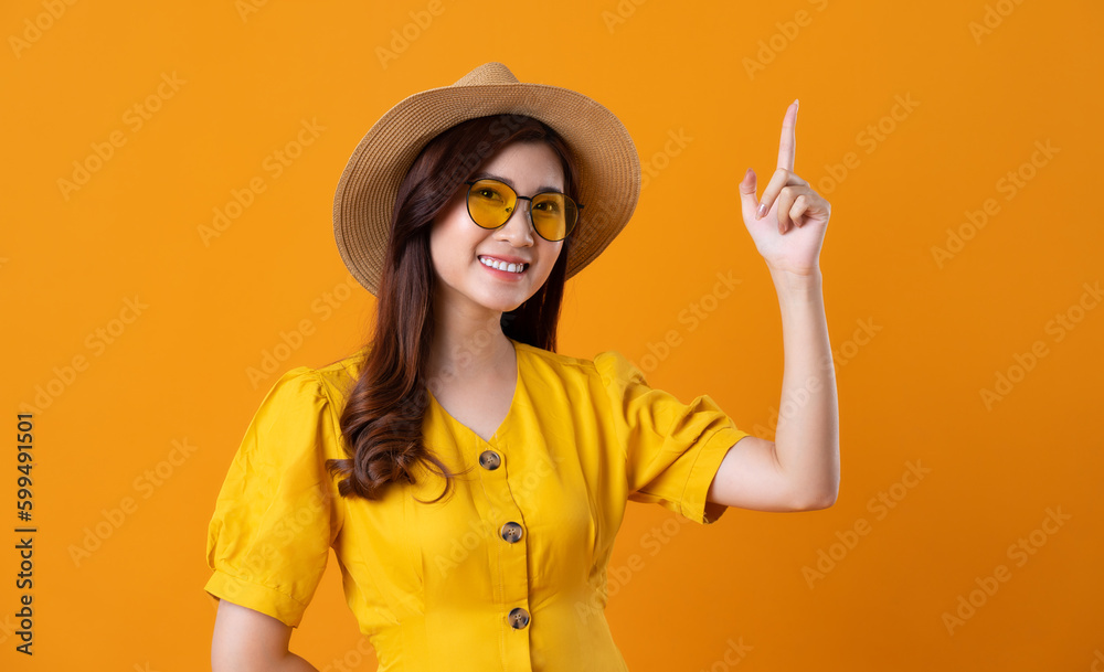 portrait of beautiful asian girl wearing yellow dress on orange ...