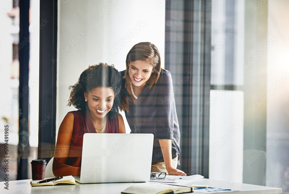 Clutching every proimsing opportunity that comes their way. two businesswomen working together on a laptop in an office. Clutching every proimsing opportunity that comes their way. two businesswomen working together on a laptop in an office.