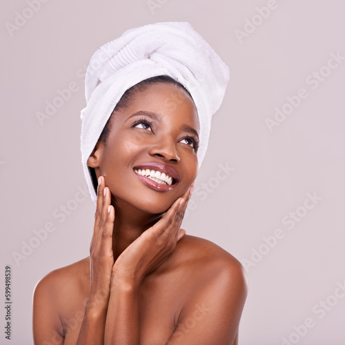 Great skin is always in. An isolated studio shot of a beautiful young woman wearing a towel on her head.