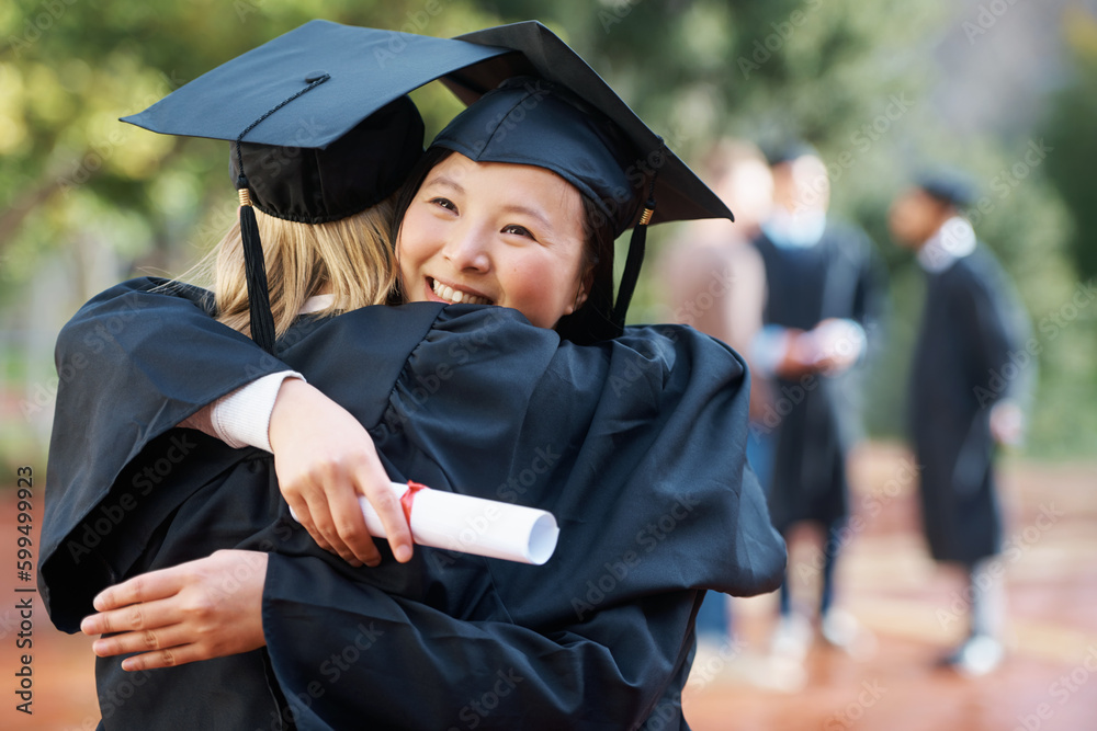 Weve finally graduated. Two college graduates hugging one another in ...