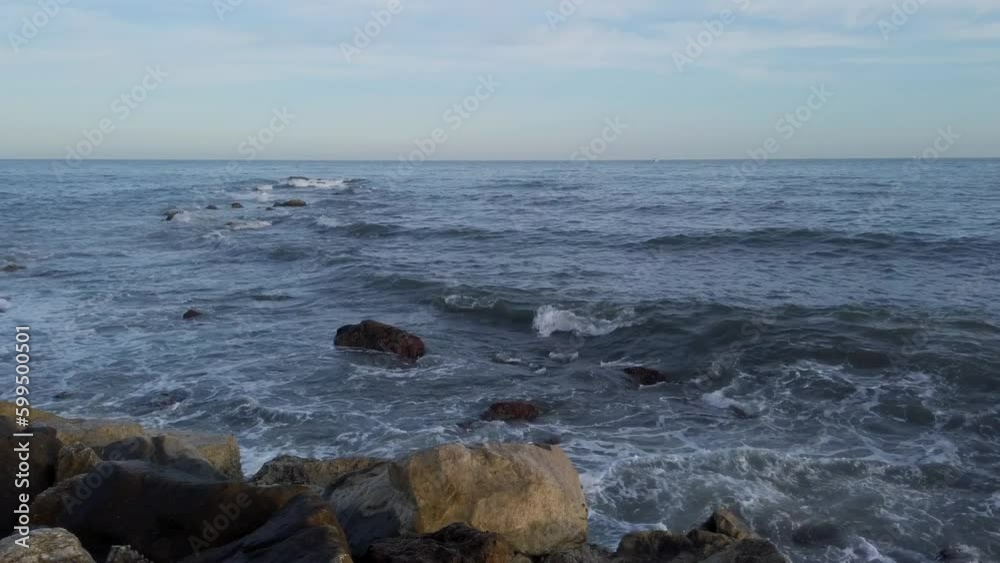 Watching Waves Crash onto the Rocks in Fuengirola, Spain Watching Waves Crash onto the Rocks in Fuengirola, Spain