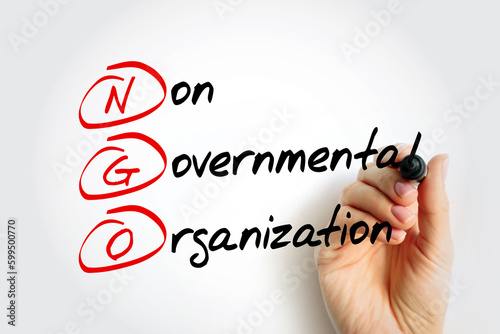 NGO - Non-Governmental Organization is an organization that generally is formed independent from government, acronym text concept with marker photo