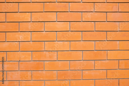 Modern orange-coloured brick wall as texture, background, pattern