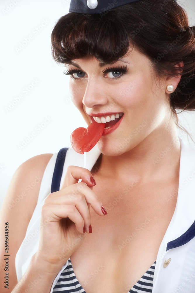 Deliciously sweet. Close up shot of an attractive pin up girl eating a lollipop. Deliciously sweet. Close up shot of an attractive pin up girl eating a lollipop.