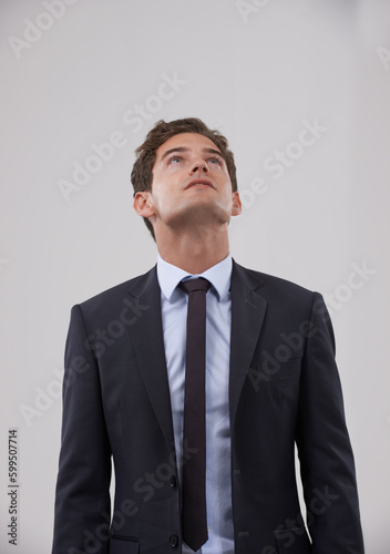 Ive set my sights high. A handsome young businessman looking up.