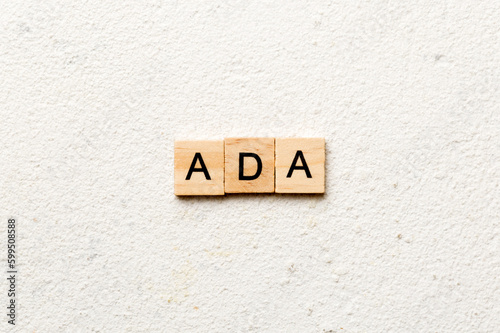 ADA word written on wood block. ADA text on table, concept photo