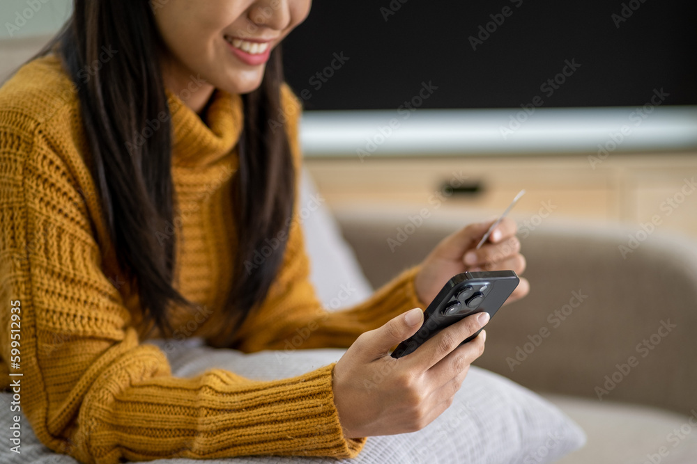 Fototapeta premium Happy smart young woman Asian using smartphone for shopping, mobile shopping, beautiful woman doing online purchases, shopping online